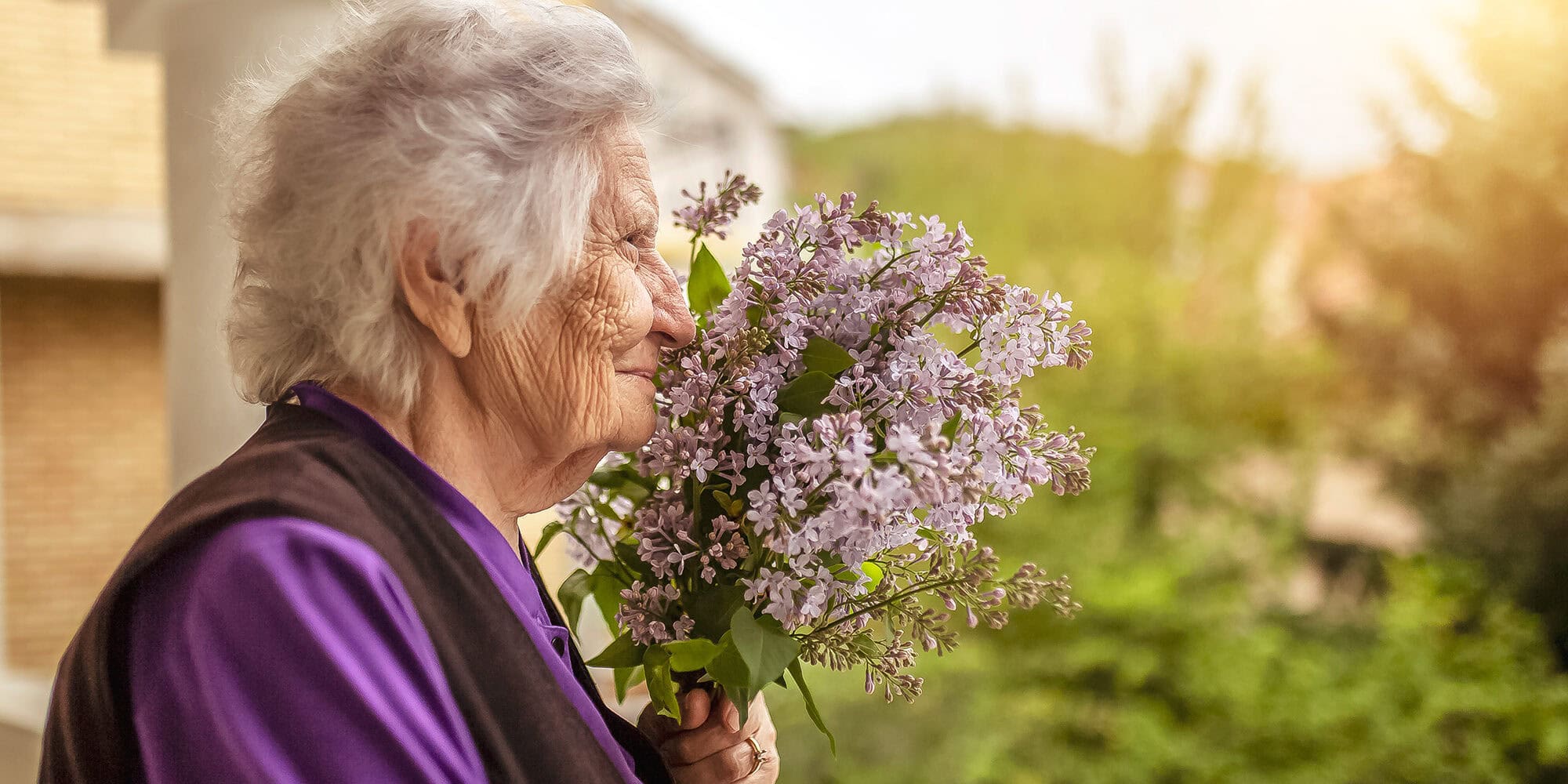 Senior woman smelling lilacs Ten Telling Signs of Dementia